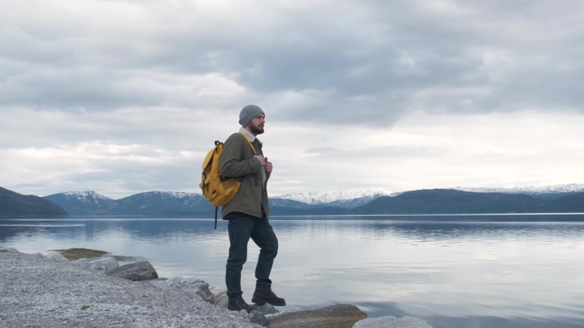 hipster walks by the river in Norway. Evening time