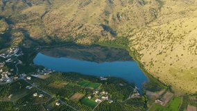 Aerial drone panoramic video of famous natural lake of Kournas with amazing colours and unique nature surrounded by mountains, Chania prefecture, Crete island, Greece