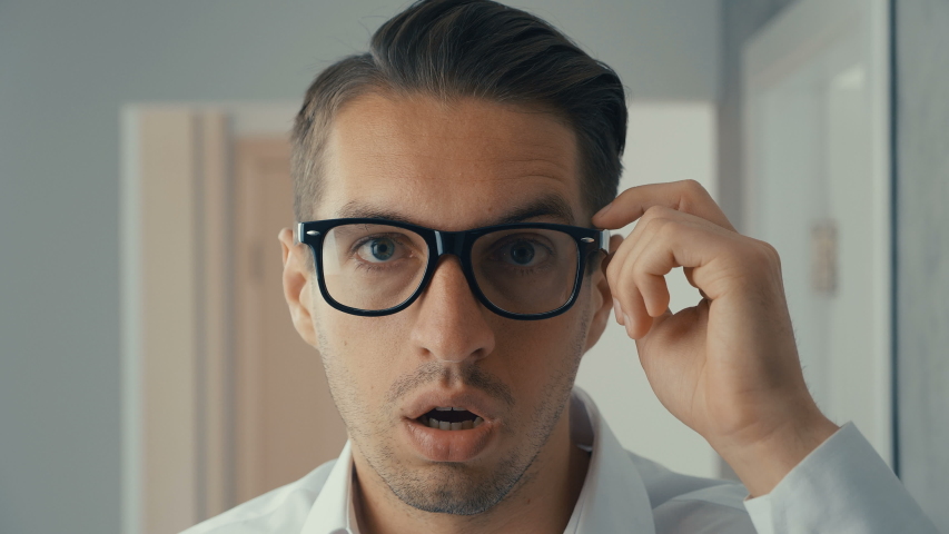 Businessman shocked and surprised. A man in surprise shoots glasses and looks at the camera in surprise. | Shutterstock HD Video #1030983155