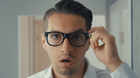Businessman shocked and surprised. A man in surprise shoots glasses and looks at the camera in surprise.