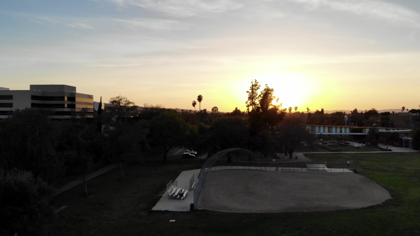 Aerial shot flying up and over baseball and soccer fields at a neighborhood park.