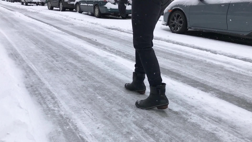 Person dancing on a ice covered street after a major snow storm in the city that shut everything down.