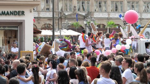 Strasbourg - Jun 8, 2019: Happy crowd of men women people lesbian and gay on truck in city center with gender symbols and multiple gay rainbow flags Bisexual Transgender LGBT GLBT visibility march