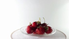 360 degrees, video red strawberries with leafs on a rotating table. 360° turn. Health food. Delicious and vitamin. Dieting and vegetarian. 