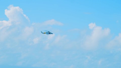 Willemstad, Curacao / Venezuela - 12 12 2018: Curacao Coastguard helicopter flying across a sunny blue sky on a beautiful day in Curacao