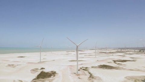 Aerial image of several wind towers and a beautiful background. Wind towers on the sand of the beach. City of Galinhos.