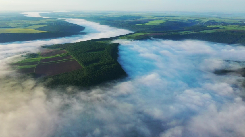 aerial view of fields on a hill above the clouds, Aerial view of Fog over the river at sunrise, thick fog over the river aerial, fog over the Dniester, river in the morning mist,