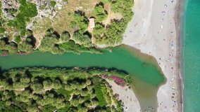 Aerial drone panoramic view video of Preveli paradise palm beach and lagoon with Palm trees in the South from city of Rethymno, Crete, Greece