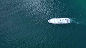 Aerial drone video of luxury yacht cruise in deep blue mediterranean bay