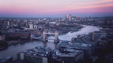 time lapse London skyline with Tower bridge and Canary Wharf in sunset time, UK