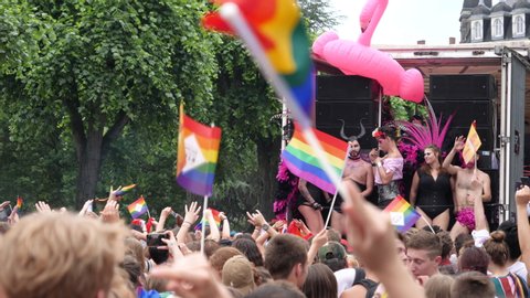 Strasbourg, France - Jun 8, 2019: Slow motion people dancing behind gay truck lesbian and gay with gay rainbow flags Bisexual Transgender LGBT GLBT celebrating pride FestiGays