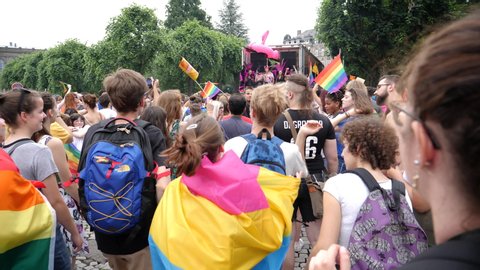 Strasbourg, France - Jun 8, 2019: Slow motion young boys and girls people lesbian and gay with gay rainbow flags dancing near Bisexual Transgender LGBT GLBT celebrating at visibility march pride 