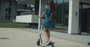 Attractive woman riding on the electric kick scooter. 4K slow motion video footage 60 fps