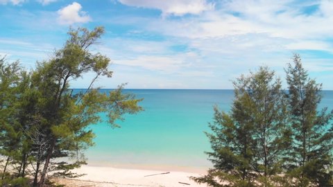 Beautiful Drone 4k footage of beautiful rural beach landscape with Beautiful white sandy beach with turquoise sea water and palm trees at Kudat, Sabah, Borneo