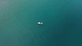 Aerial video with drone, boat on water, Lake Garda, Italy.