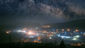 Seamlessly loopable timelapse of the starry night sky over mountain town  - Powered by Shutterstock - Get 15% off with code: PIKWIZARD15