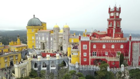 The Pena Palace, a Romanticist castle in the municipality of Sintra, Portugal, Lisbon district, Grande Lisboa, aerial view, shot from drone. Camera moves