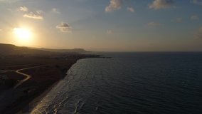 Aerial video of a sunset lighting the sea