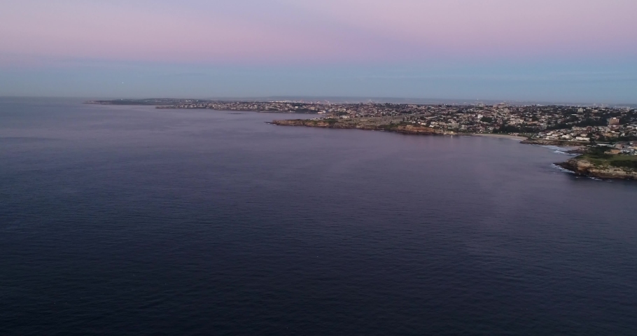 Pacific ocean coast of Sydney city along Eastern suburbs around Bondi beach in sunrise aerial panorama.
