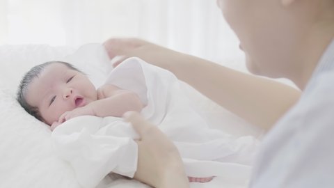4K Mother take care her adorable newborn baby carefully with love