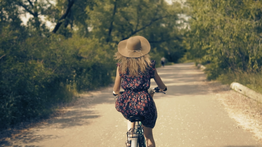 Woman Cyclist Happy Travel Hair Blowing On Bicycle. Cycling Girl In Hat Cycling Bike Sport Recreation. Woman Hair Fluttering. Adorable Cyclist Recreation Workout. Vacation Holiday Fun Cycling Sport Royalty-Free Stock Footage #1031089130
