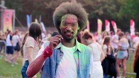 Swipe up video of African man at the holi festival
