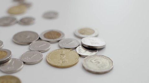 Slow pan on various Israeli coins - NIS / shekels / sheqels