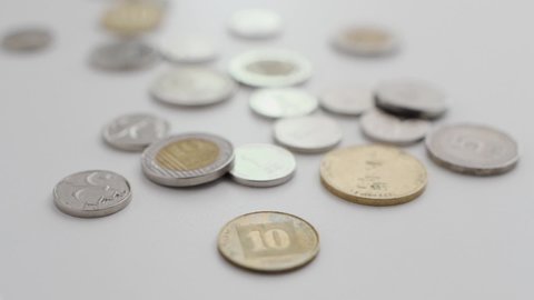 Pushing in move into a group of Israel's currency - shekel coins