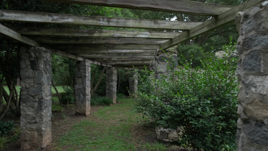 Walking through a decorative archway in a beautiful garden of blooming roses in Raleigh, North Carolina