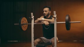 Muscular bearded powerlifter in white socks training with barbell