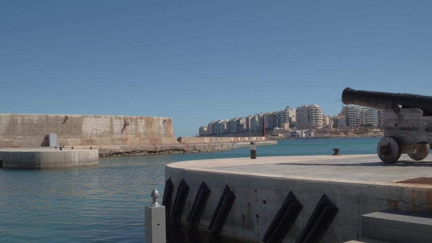 A cannon in the foreground with the the building in Tower Road as the background