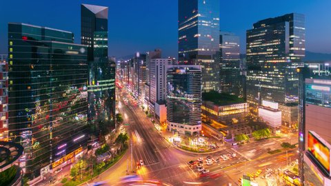 Seoul city Skyline and Skyscraper and Traffic at night intersection in Gangnam, South Korea. 4K Timelapse