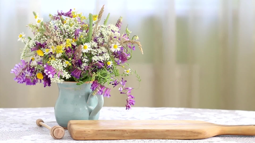 Woman sets jars with honey on the table. 
