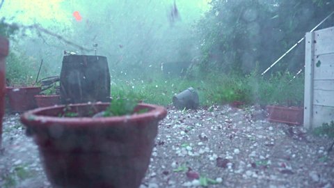 Thunderstorm with huge hailstones causing damage in urban backyard
