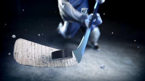 Hockey player in blue uniform hits the puck in slow motion. Excellent close-up (4k, 3840x2160, ultra high definition)