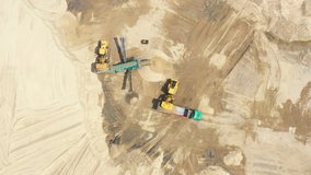 Aerial view loading bulldozer in open air quarry. Sand mining industry. Bulldozer machine. Crawler bulldozer moving at sand mine. Mining machinery working at sand quarry. Drone view of mining equipmen