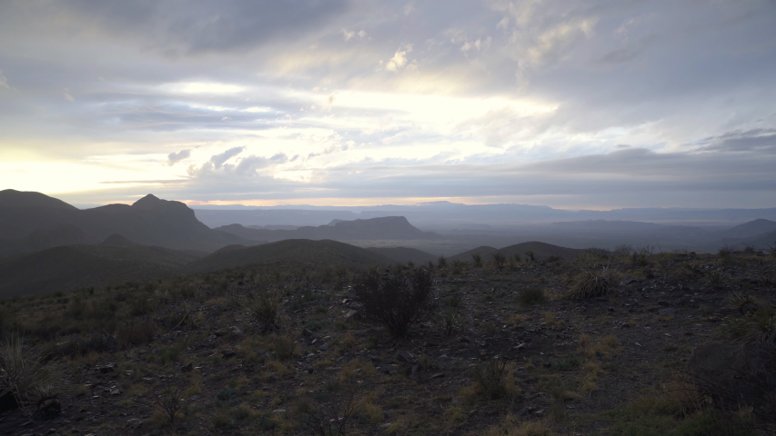 Wild west with beautiful sunset over mountains. Dolly shot right, establishing shot
