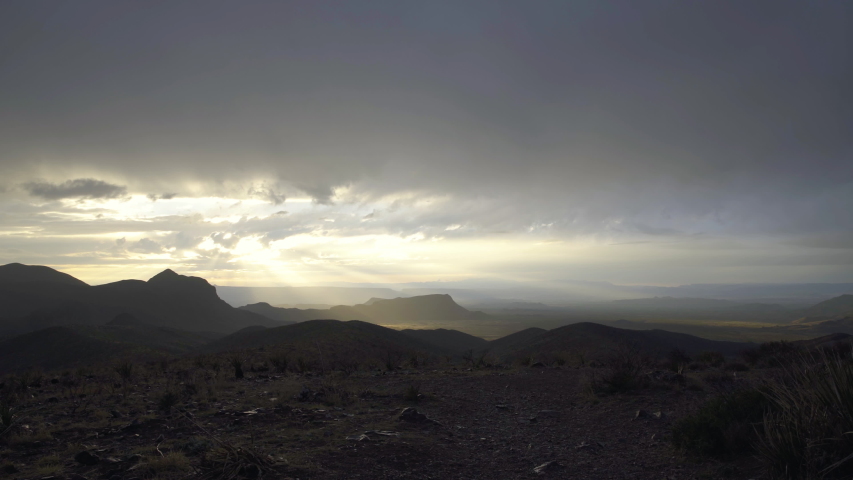 Heavenly golden sun rays shining on a dry desert landscape