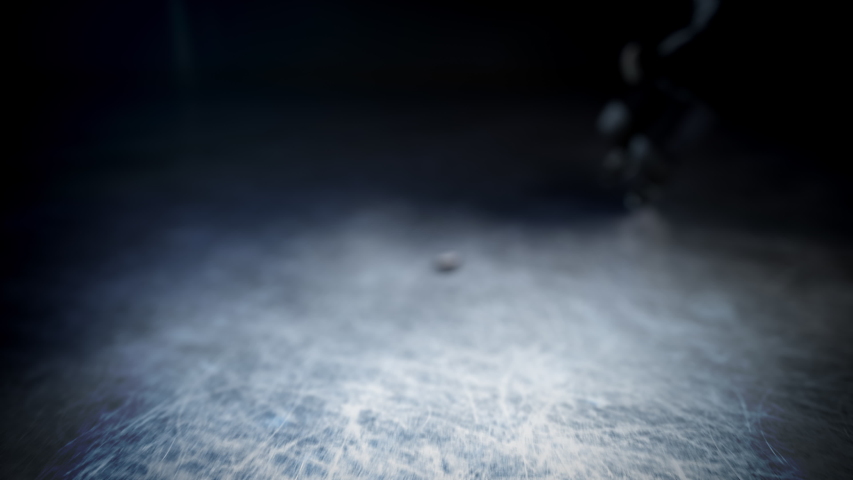 Hockey player in black uniform hits the puck in slow motion. Beautiful close-up (4k, 3840x2160, ultra high definition) Royalty-Free Stock Footage #1031165156