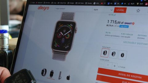 WROCLAW, POLAND - JUNE 10, 2019: Man use Laptop to buy an iwatch electronic Watch on Internet Market Allegro