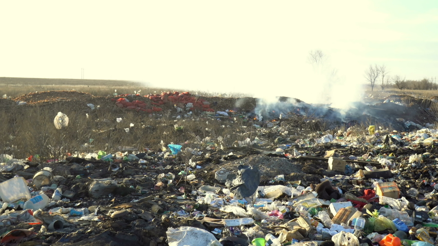 Volgograd, Russian Federation - March 12, 2017: Large garbage dump waste with smoke at sunny day | Shutterstock HD Video #1031178020
