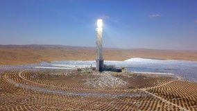 Solar power tower and mirrors that focus the sun's rays upon a collector tower to produce renewable, pollution-free energy, Aerial footage.