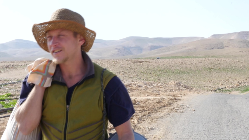 Portrait of young man hiking on Negev Desert in Israel