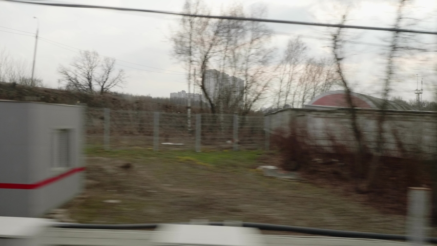 Train passes under overpass. View from window of moving train. Train journey