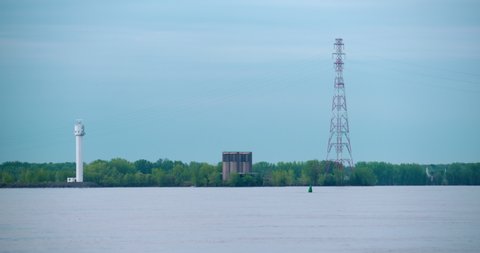 Montreal, Quebec / Canada - 06 01 2019: Ile Charon radar site of Canadian Coast Guard and ventilation tower of Louis-Hippolyte Lafontaine Bridge–Tunnel and Hydro-Quebec power lines.