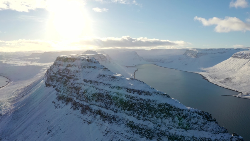 Mountain out of the ocean with clouds over top in Iceland image - Free ...