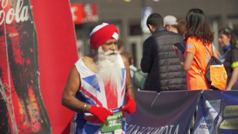 Barcelona, Spain. March 10th 2019: Sikh Old Man with long white beard running a Marathon in Barcelona. Wears turban and a t-shirt with the flag of the United Kingdom