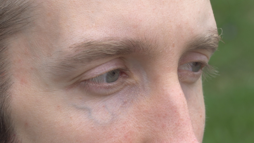 Close up of man's blue eyes looking off into the distance Royalty-Free Stock Footage #1031247368