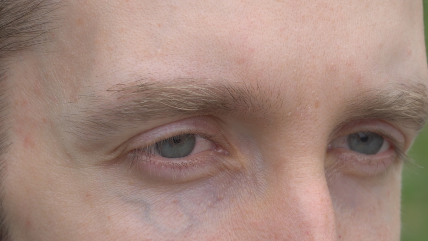 Close up of man's blue eyes looking off into the distance Royalty-Free Stock Footage #1031247371