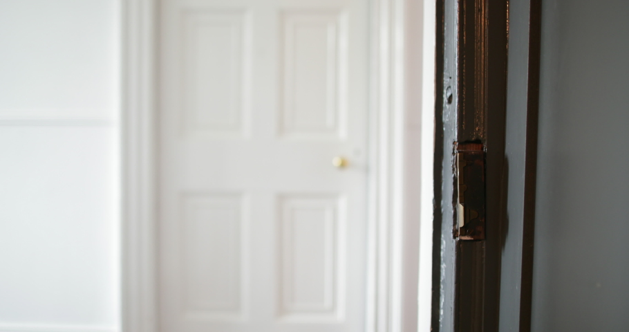 Close-up of a old fashioned door and door handle in a house. The door swings towards the lock to close and lock. Royalty-Free Stock Footage #1031250638